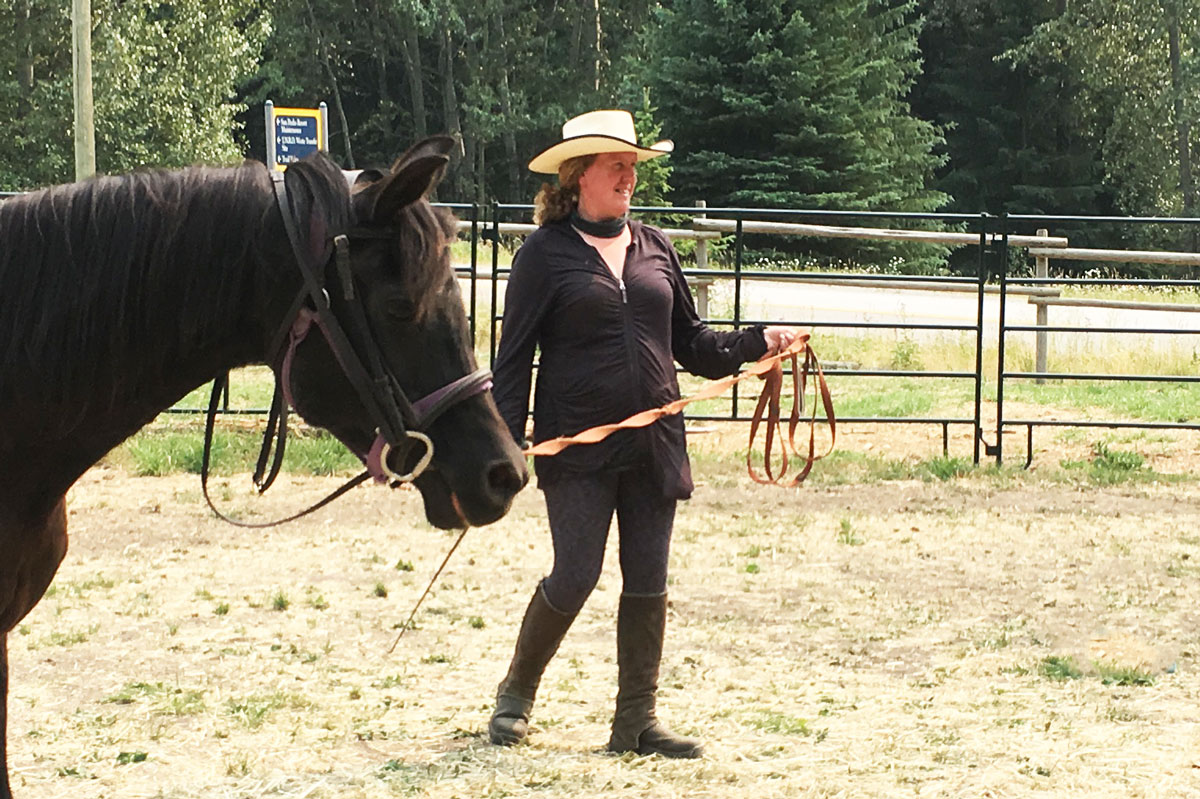 image of Rebecca leading a horse